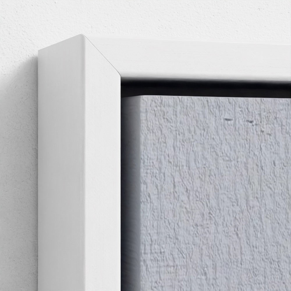 Close-up of a white frame corner on a textured gray wall.