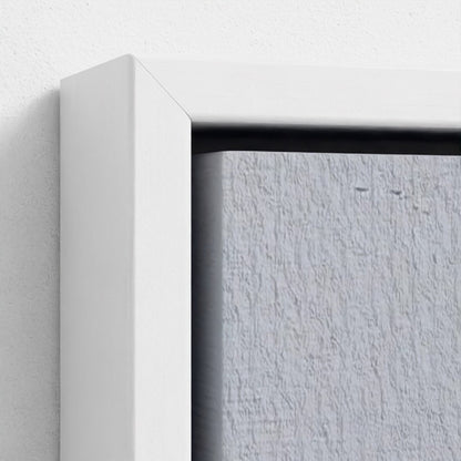 Close-up of a white frame corner on a textured gray wall.