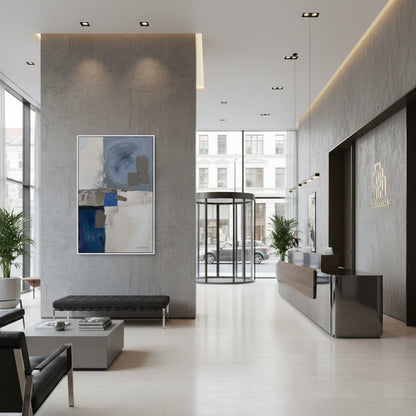 Modern lobby with abstract art, reception desk, and glass door.