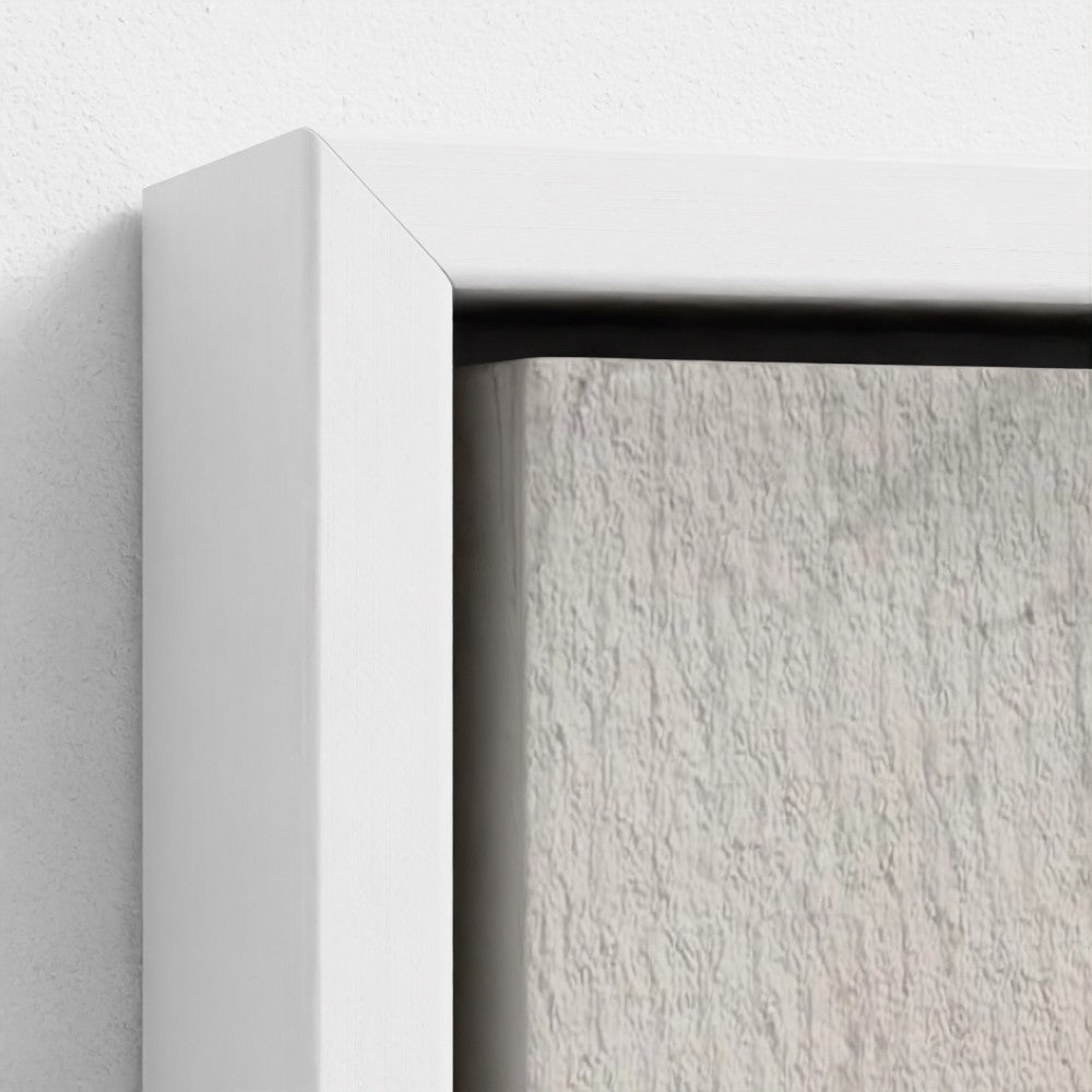 Close-up of a white frame corner with a textured gray background