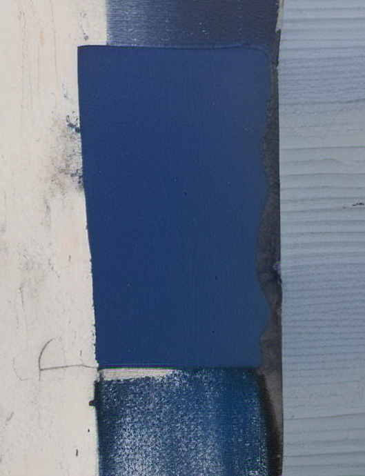 Close-up of a blue rectangular object on a textured surface