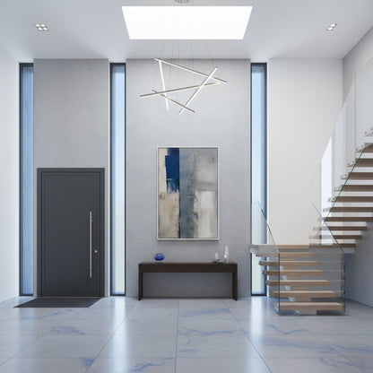 Modern interior with a staircase, wall art, and a door.