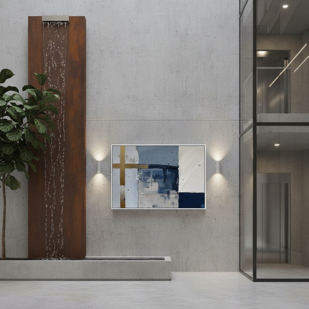 Modern interior with abstract art on a wall, plant, and water feature.