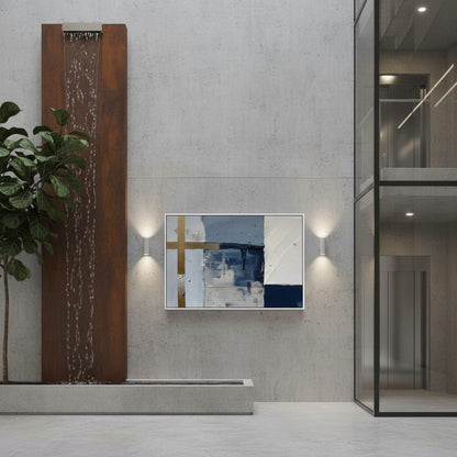 Modern interior with abstract art on a wall, plant, and water feature.