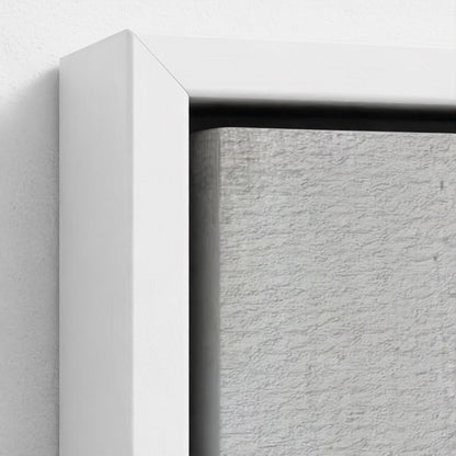 Close-up of a textured gray wall with a white frame.