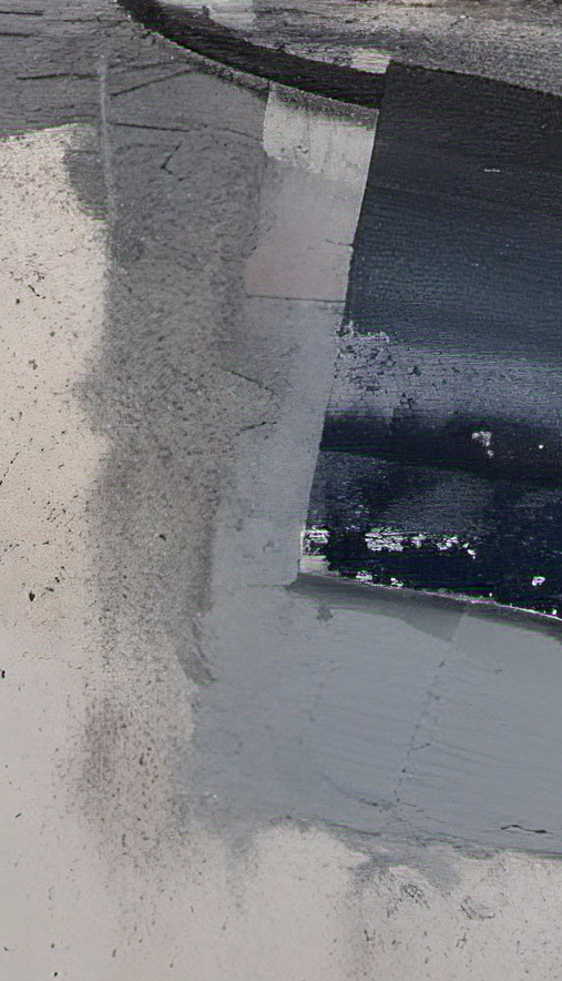 Close-up of a concrete surface with a crack and some debris.