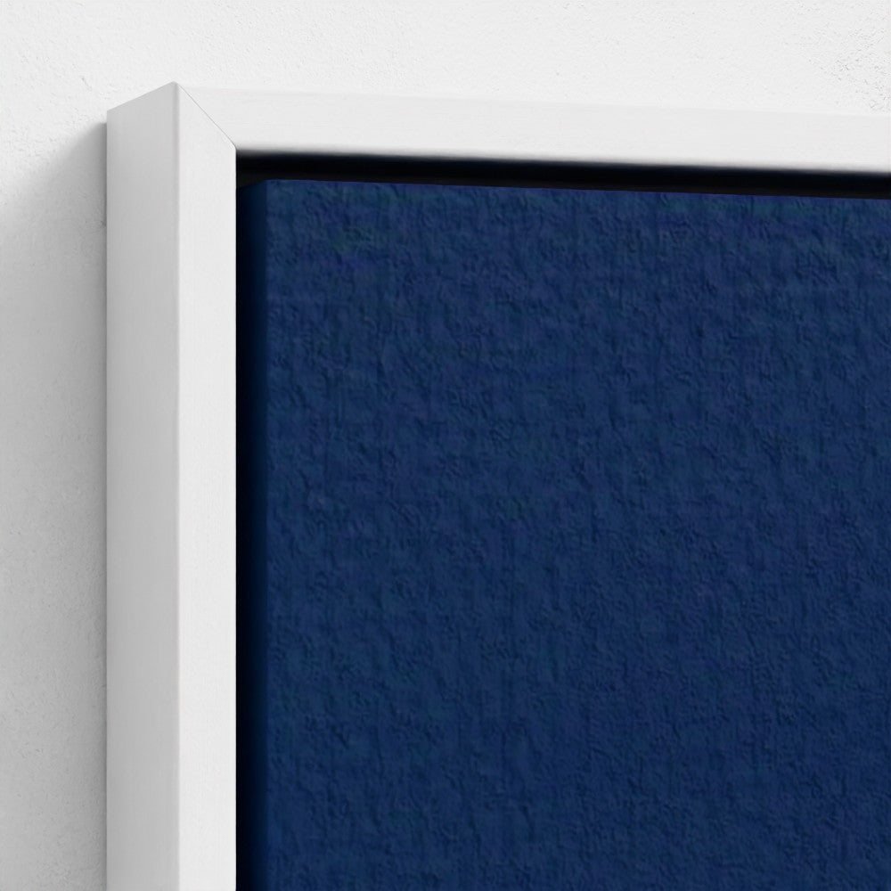 Close-up of a blue textured wall with a white frame.