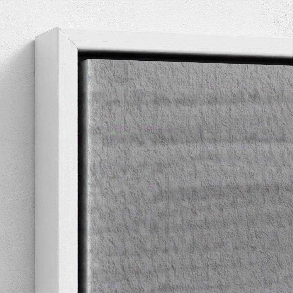 Close-up of a textured gray panel with a white frame on a light gray background