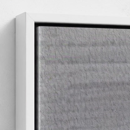 Close-up of a textured gray panel with a white frame on a light gray background