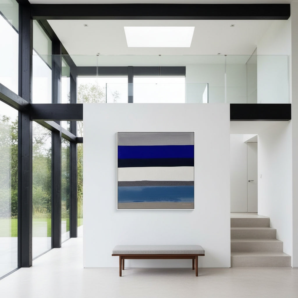 Modern interior with a abstract painting on a white wall, bench, and glass walls.