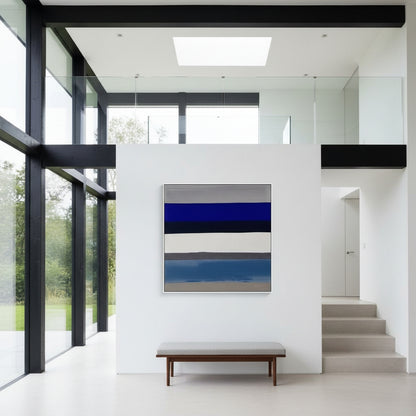 Modern interior with a abstract painting on a white wall, bench, and glass walls.