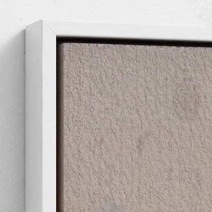 Close-up of a textured wall with a white frame.