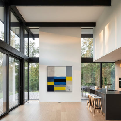 Modern kitchen with large windows, abstract painting, and stools.