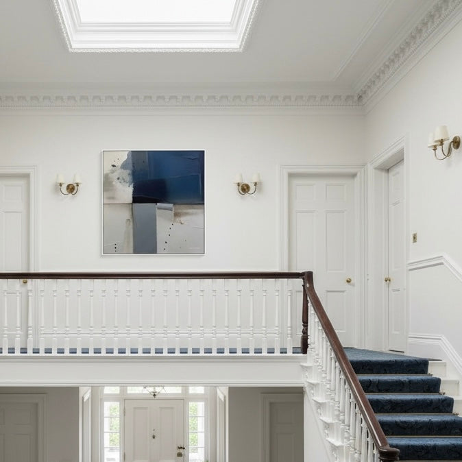 Staircase with white walls and a painting in a formal setting