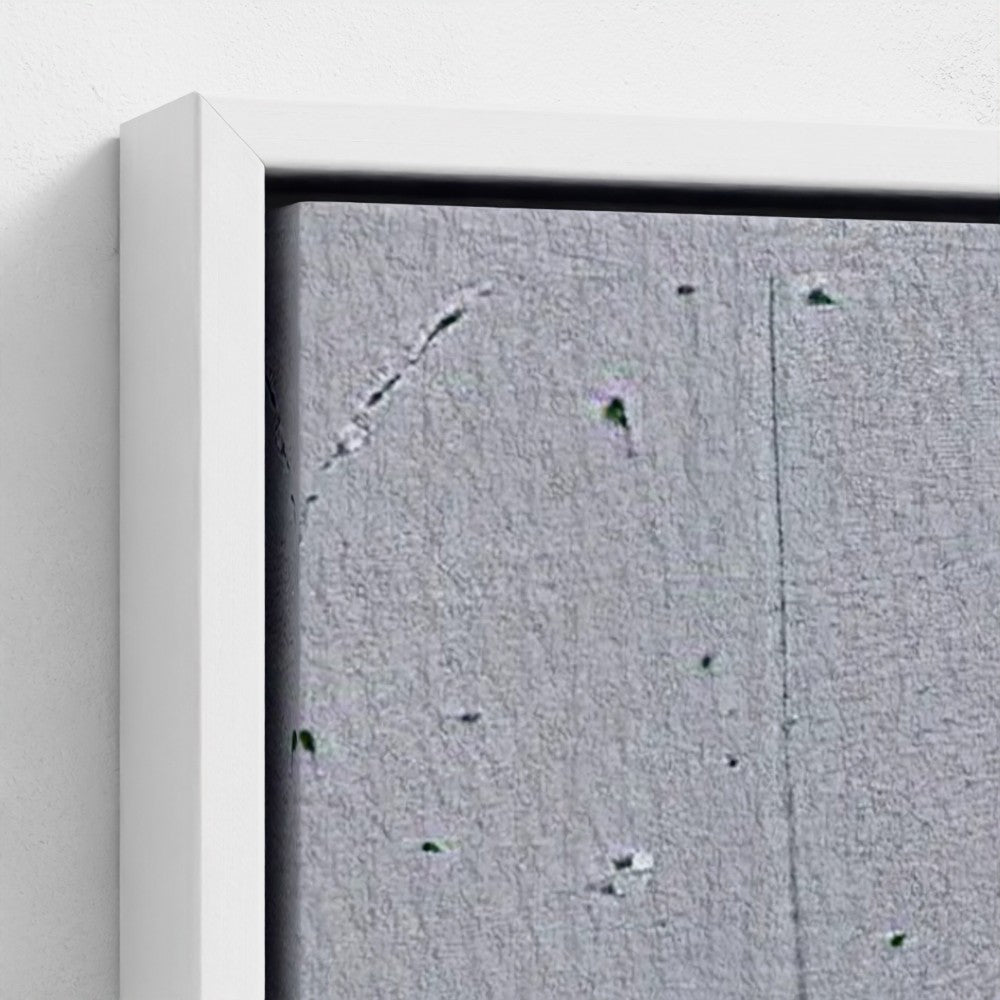 Close-up of a textured gray surface with a white frame.