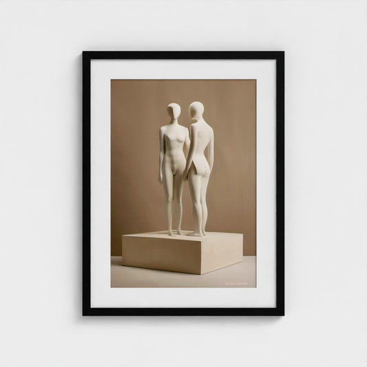 Framed artwork of two abstract sculptures on a beige platform against a beige wall.