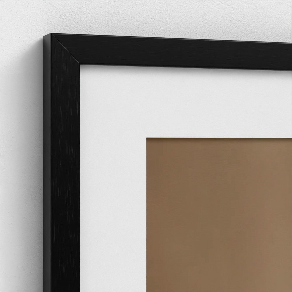 Close-up of a black picture frame on a white wall.