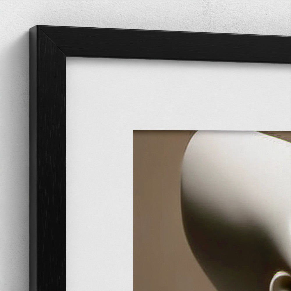 Framed artwork with a black frame on a white wall
