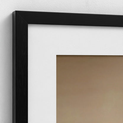 Close-up of a black picture frame on a white wall.