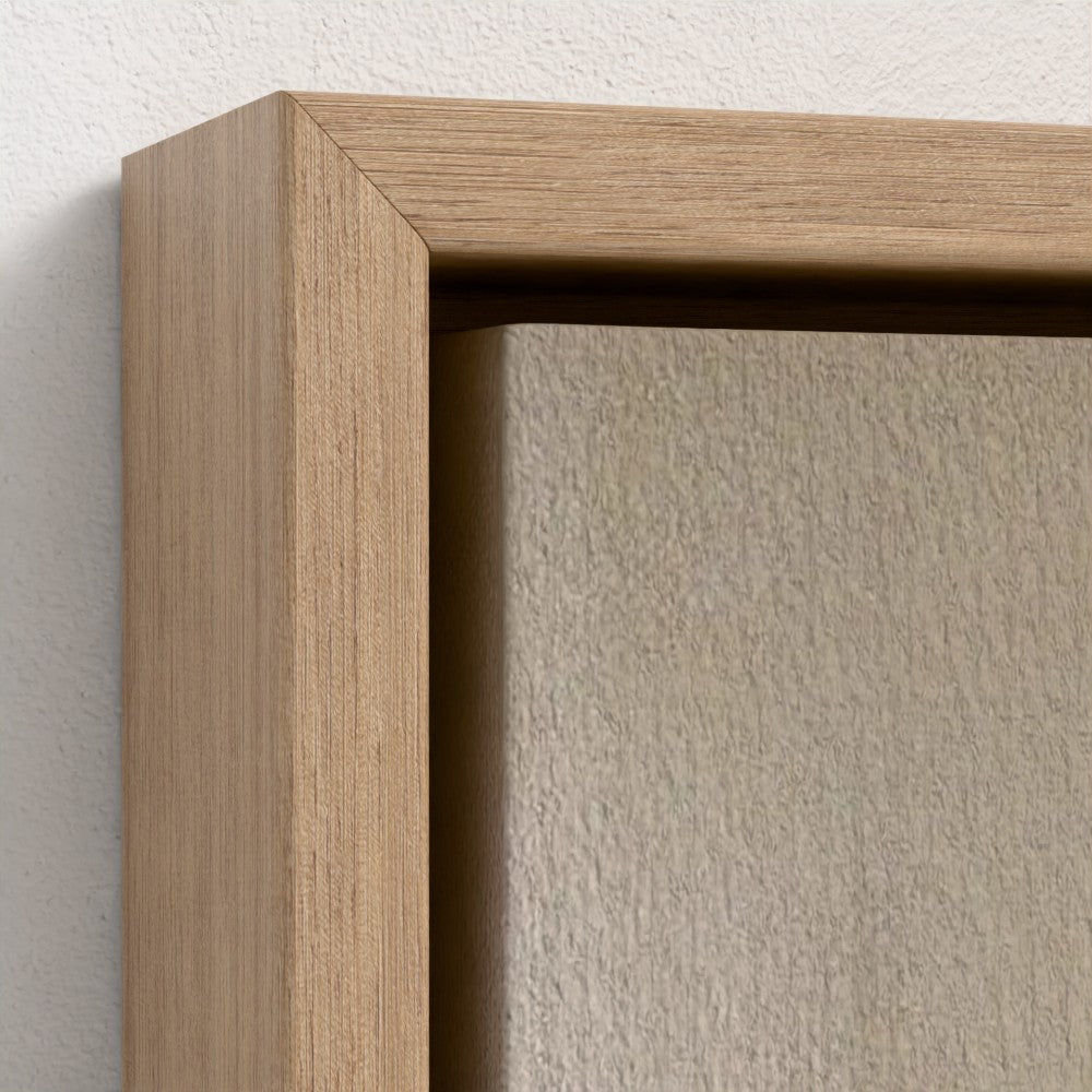 Close-up of a wooden picture frame corner on a textured wall.