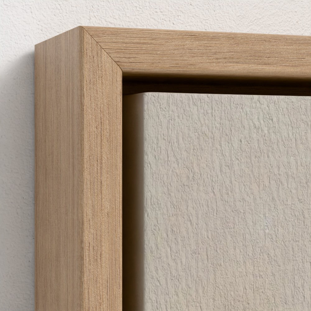 Close-up of a wooden picture frame on a white wall.