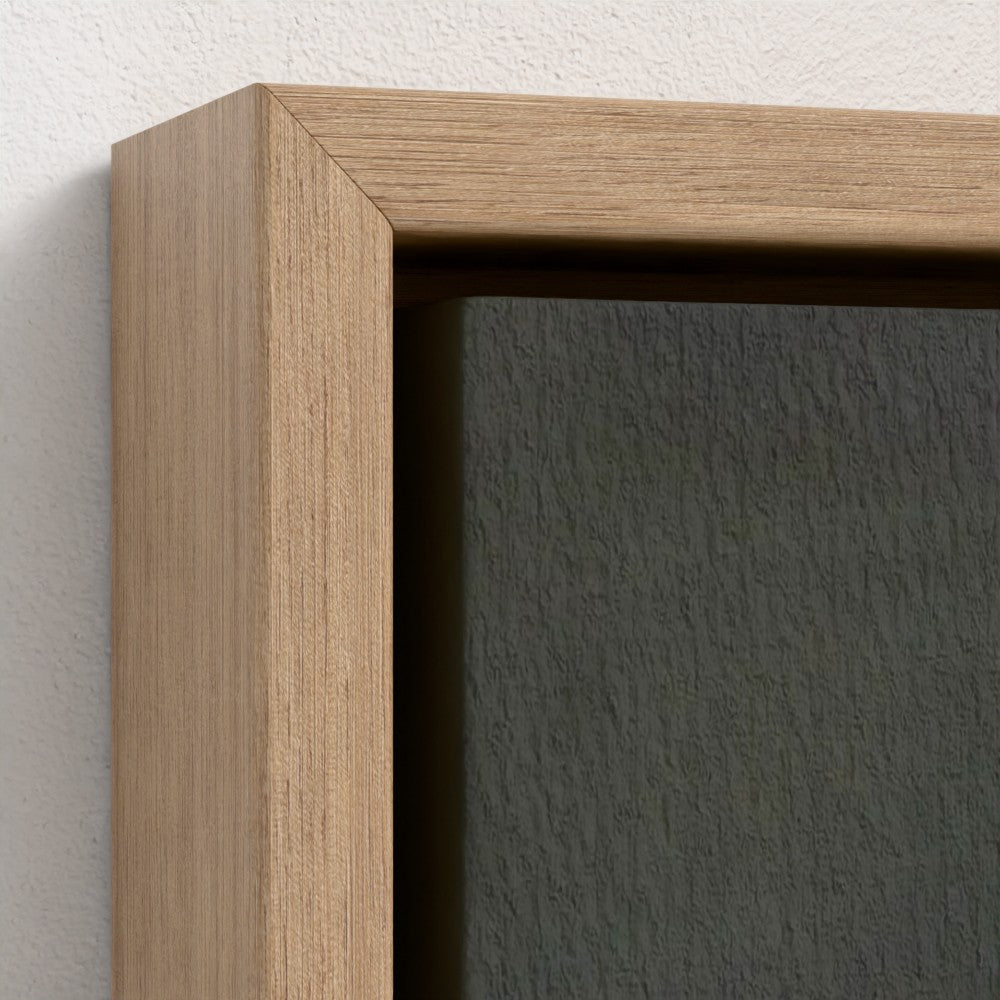 Close-up of a wooden picture frame with a dark gray wall background