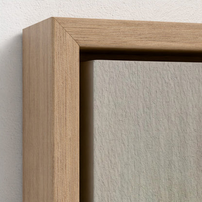 Close-up of a wooden picture frame corner on a textured wall.