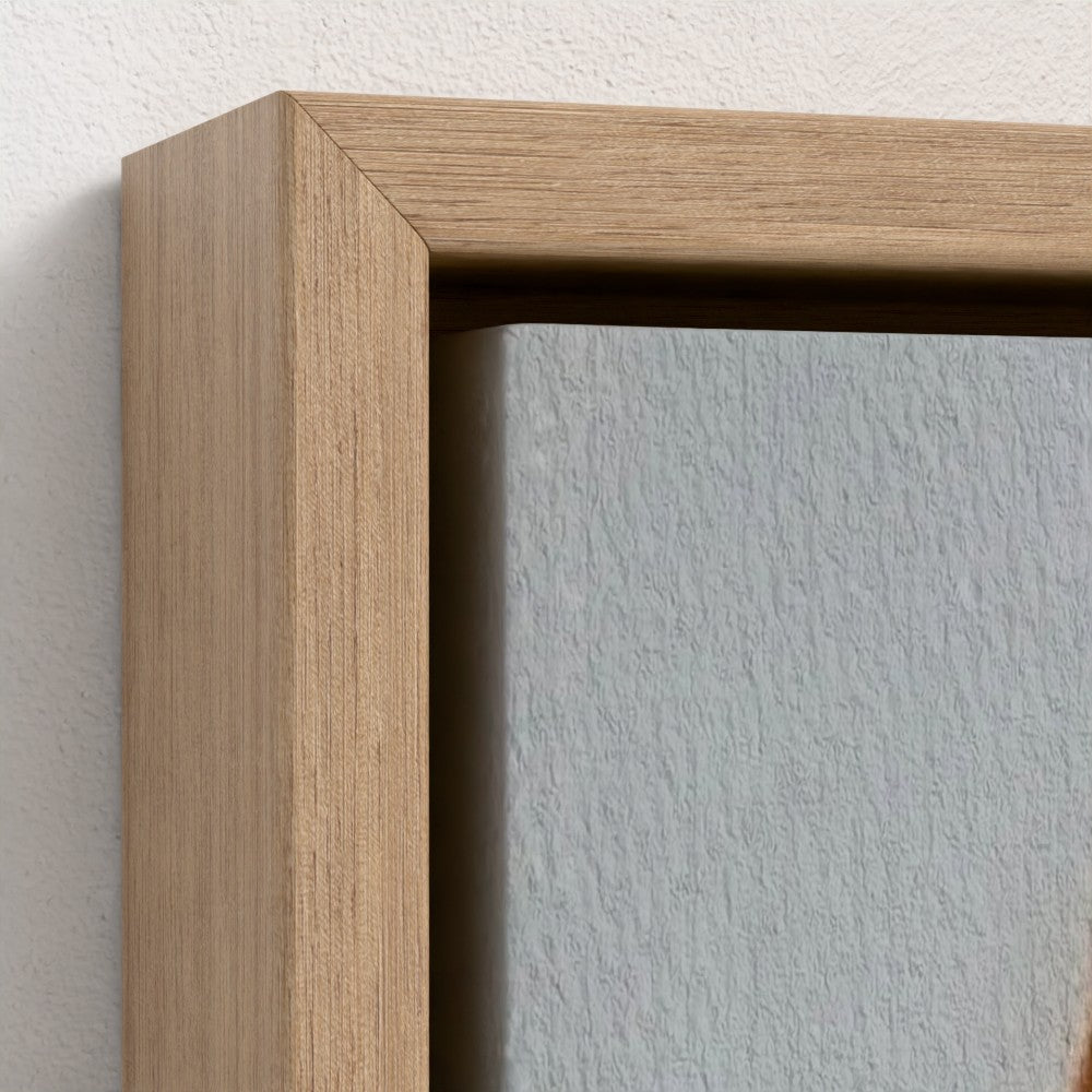 Close-up of a wooden picture frame against a light gray wall.