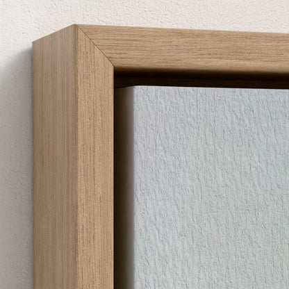 Close-up of a wooden picture frame corner on a white wall.