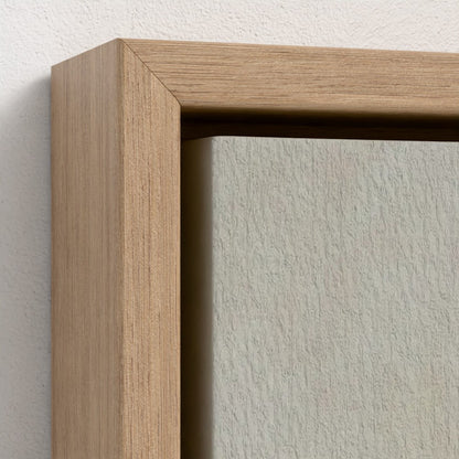 Close-up of a wooden picture frame on a textured wall.