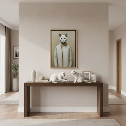 Modern interior with a wooden console table, decorative items, and a framed portrait of a cat wearing a coat on the wall.