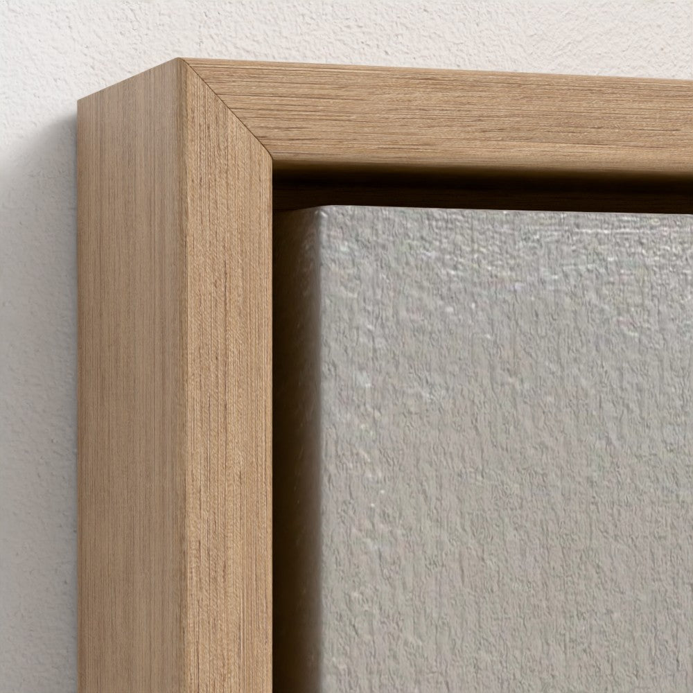 Close-up of a wooden picture frame corner on a white wall.