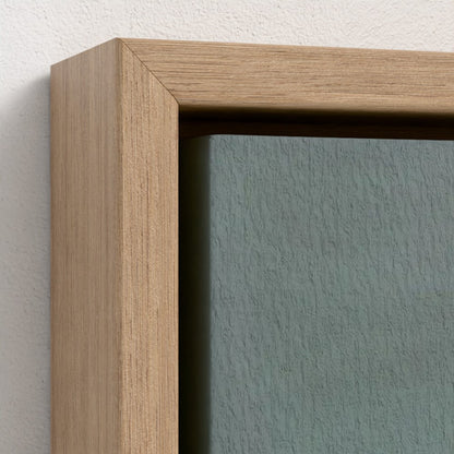 Close-up of a wooden frame with a textured green wall background