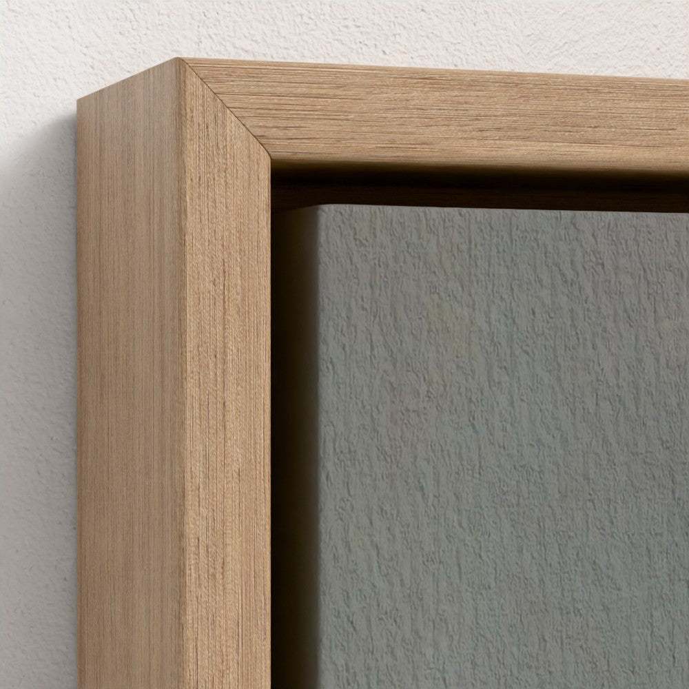 Close-up of a wooden picture frame corner on a white wall.