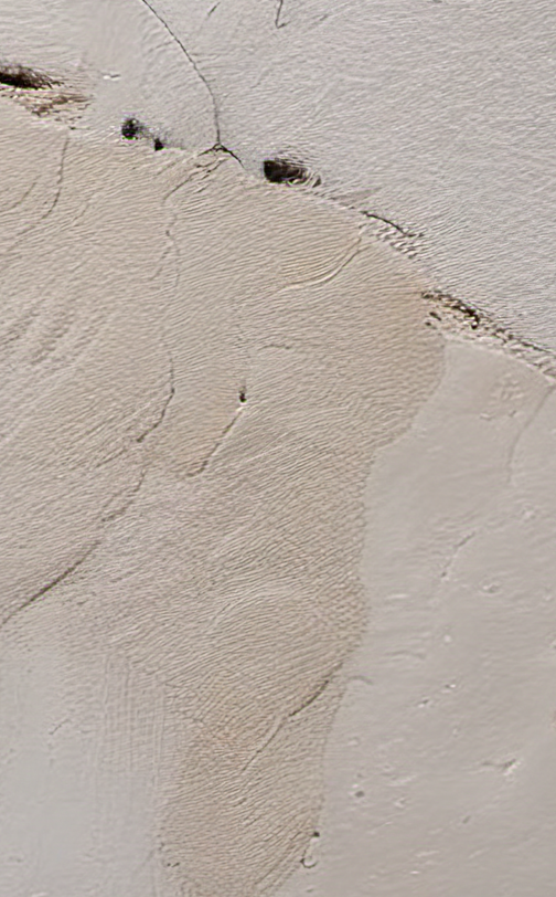 Close-up of textured beige wall with cracks and small stones