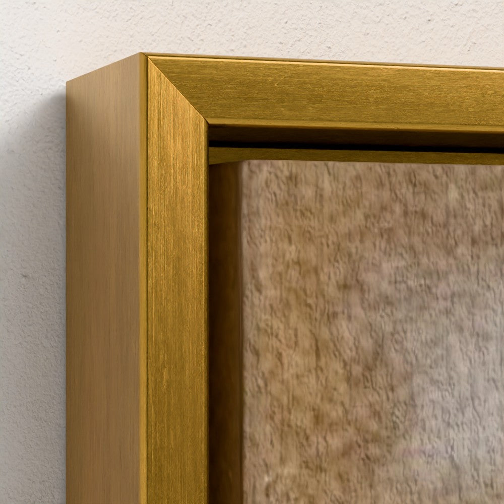 Close-up of a gold framed mirror on a textured wall.