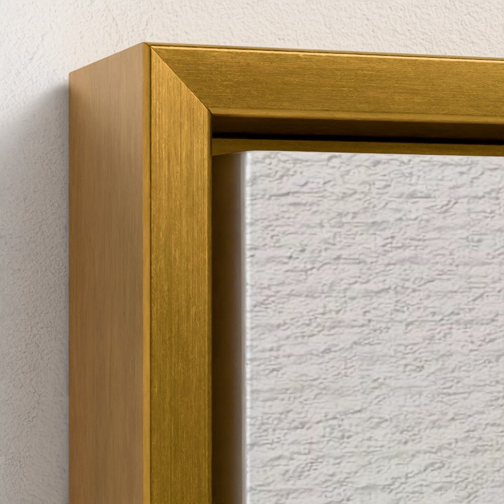 Close-up of a gold framed mirror on a textured white wall.