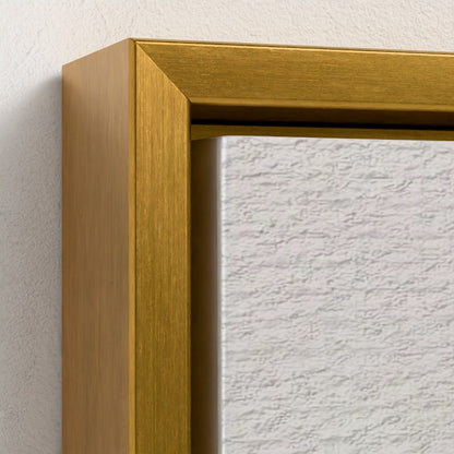 Close-up of a gold framed mirror on a textured white wall.