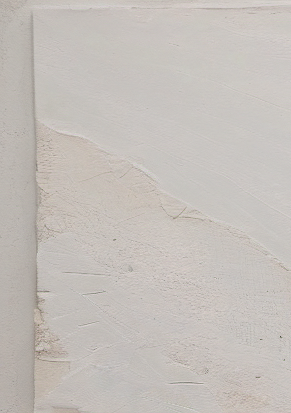 Textured white wall with a corner showing signs of wear