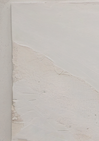 Textured white wall with a corner showing signs of wear