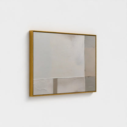 Square mirror with gold frame on a white wall