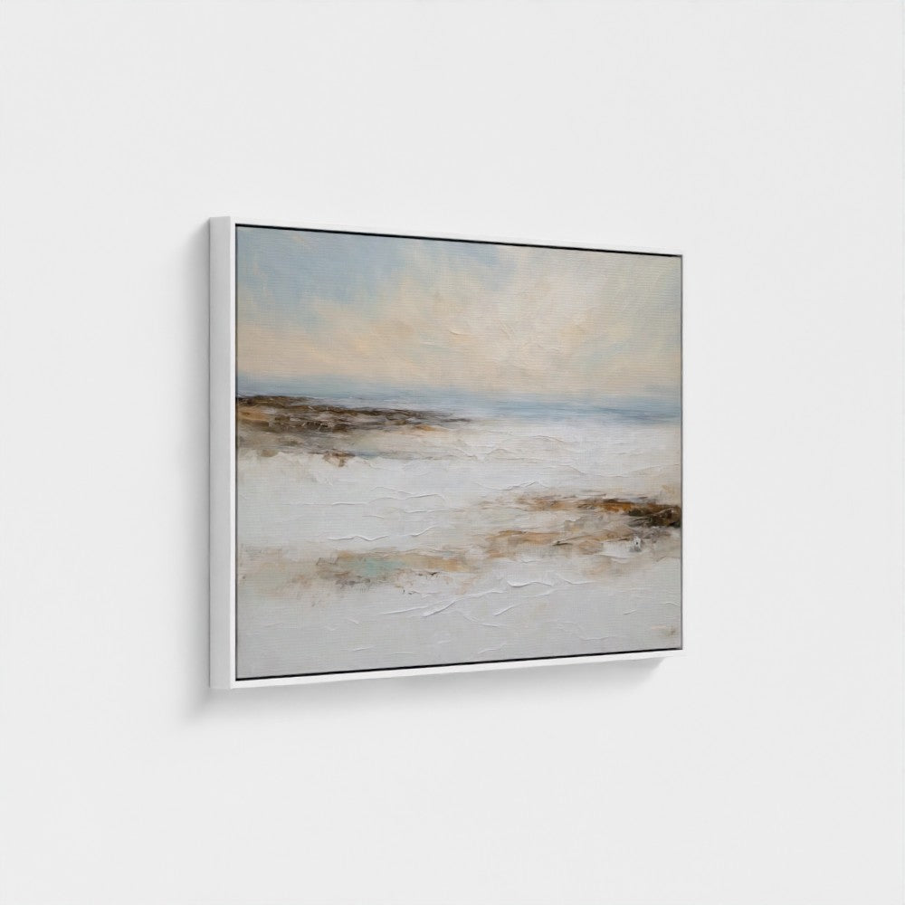 Framed artwork of a landscape with a beach and sky on a white wall