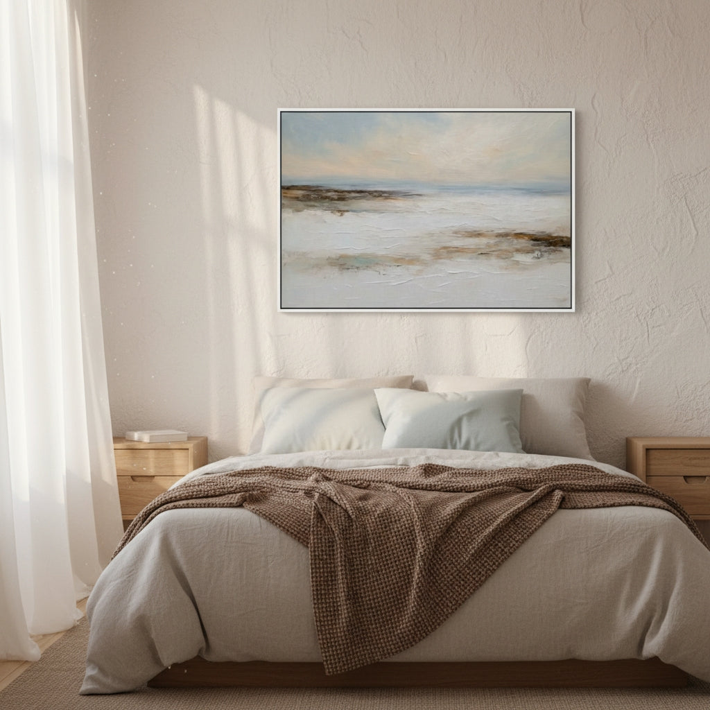 Bedroom with a bed, brown blanket, and framed artwork on the wall.