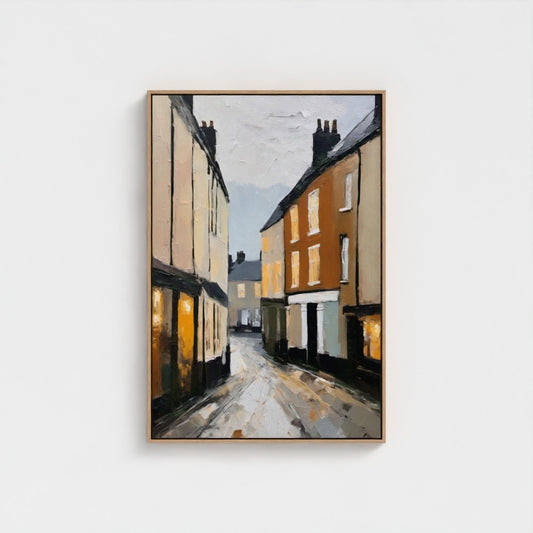 Framed painting of a street scene with houses on a white background