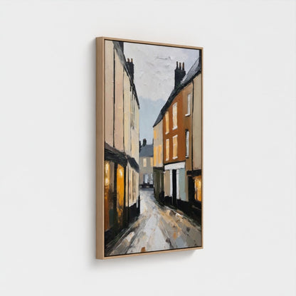 Framed painting of a street scene with houses on a white background
