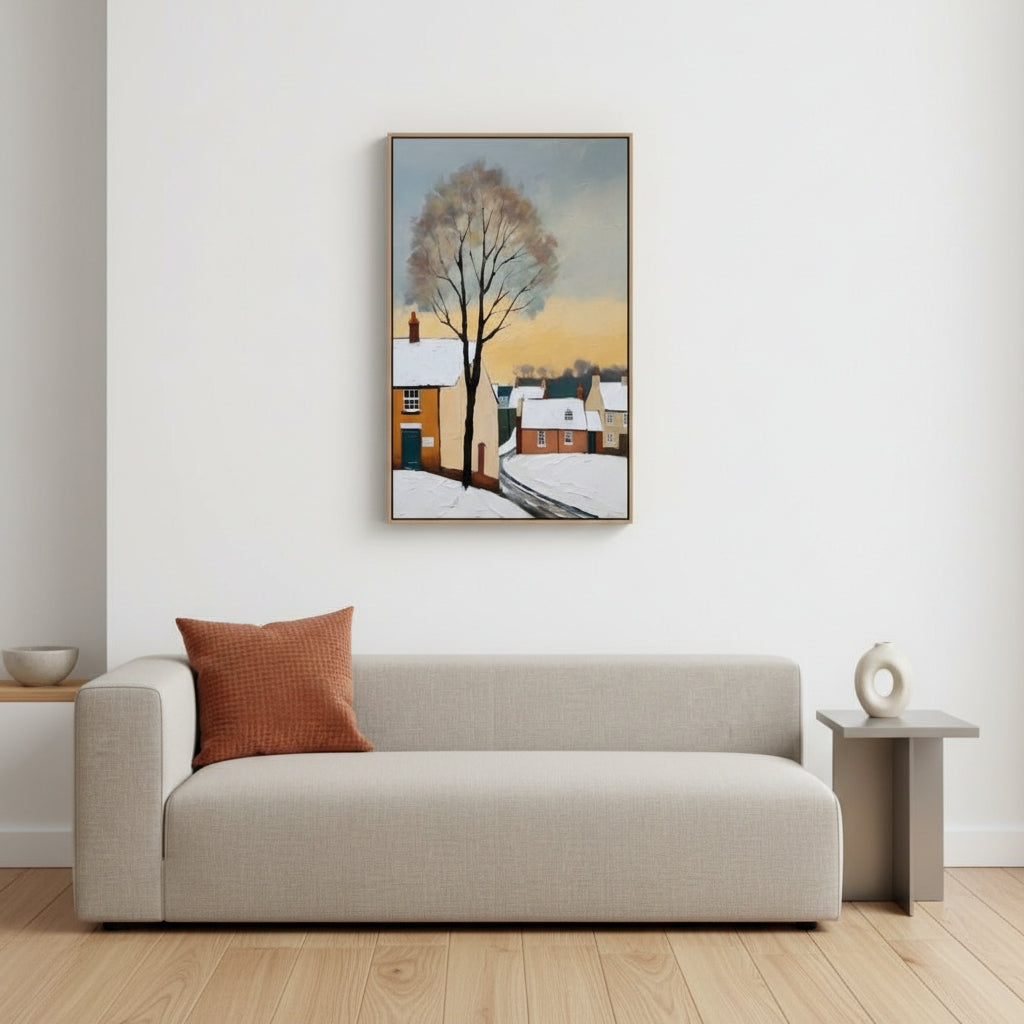 Living room with a beige sofa, brown pillow, and a painting of a snowy village on the wall.