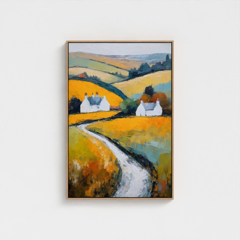 Framed painting of a rural landscape with houses and a path on a white wall.