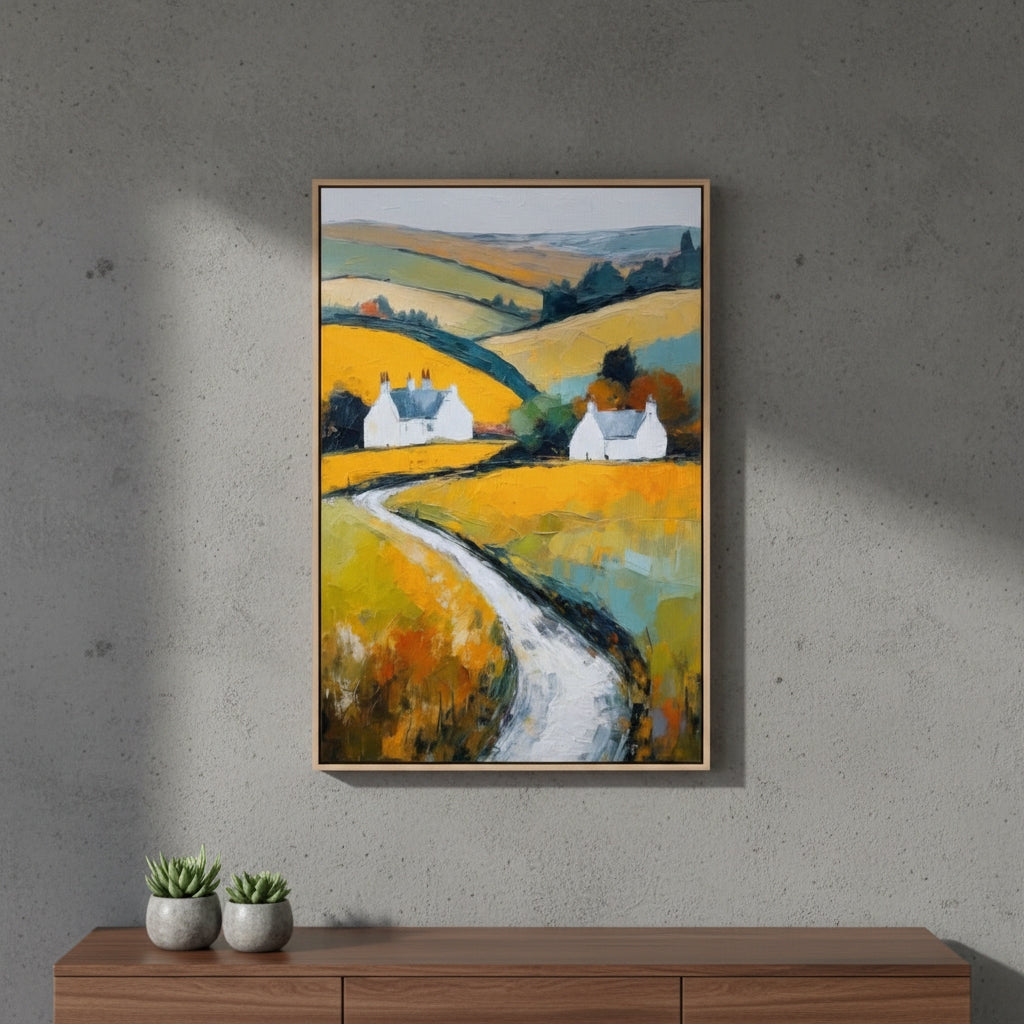 Framed painting of a colorful landscape with houses on a gray wall above a wooden console table.