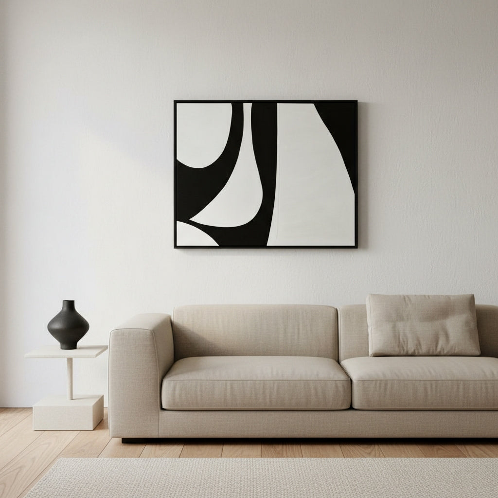 Modern living room with a beige sofa and abstract black and white artwork on the wall.