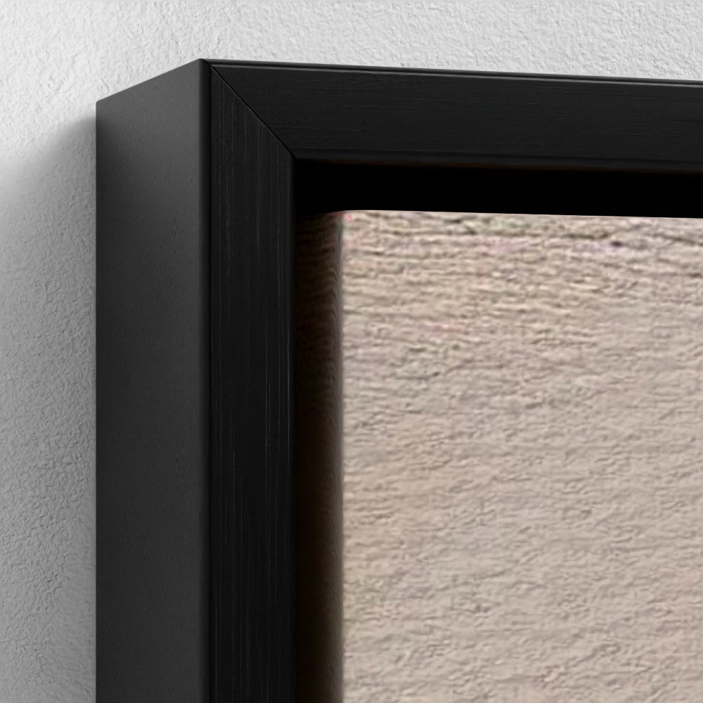 Close-up of a black picture frame corner on a textured wall.